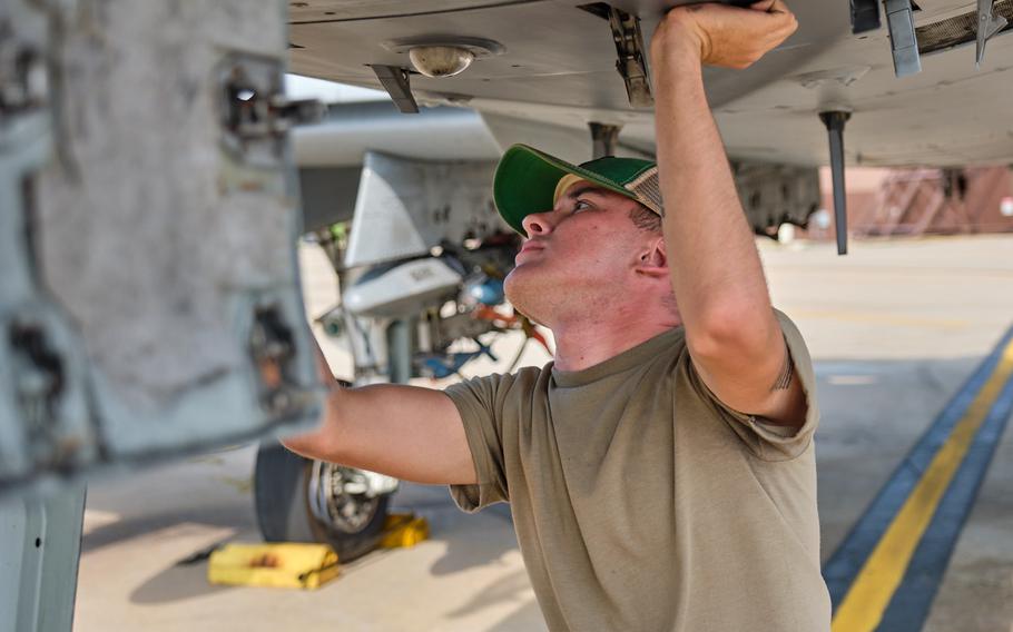 Airman 1st Class Chrisdien Scarlett, a crew chief with the 25th Aircraft Maintenance Unit, wears a bump cap as he inspects an A-10 Thunderbolt II at Osan Air Base, South Korea, Wednesday, Aug. 28, 2019.