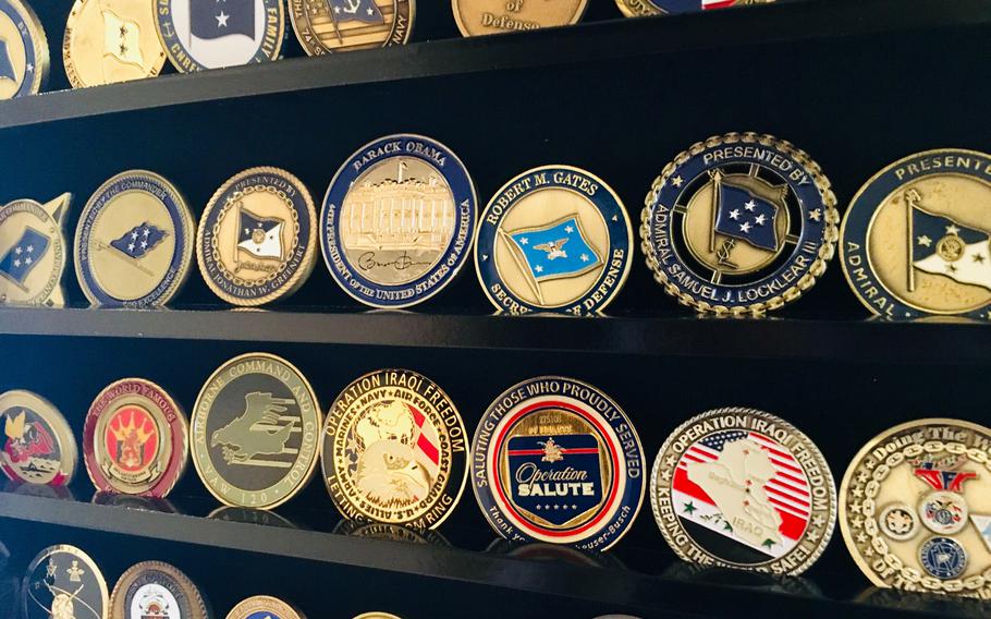 A display case features command and flag officer coins on August 28, 2019. The origin of commanders presenting coins to deserving sailors is disputed, but some historians think the tradition in U.S. history stems from the U.S. Civil War.