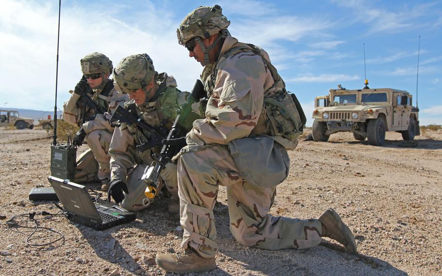 Cyberspace operations soldiers, from left, Spc. Ashley Lethrud-Adams, Pfc. Kleeman Avery and Sgt. Alexander Lecea, 782nd Military Intelligence Battalion, provide cyberspace operations support while training at the National Training Center, Fort Irwin, Calif., Jan. 13, 2019.