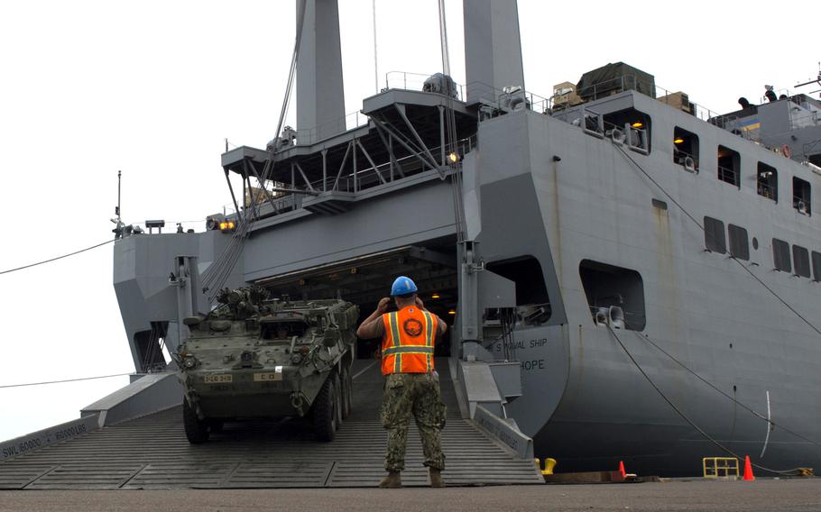 A U.S. Navy seaman directs cargo arriving off of U.S. Naval Ship Bob Hope as part of a turbo activation at the Port of San Diego in August 2017. U.S. Transportation Command began a similar turbo activation Monday to test the ability to get forces across oceans in the event of a fight with Russia or China.