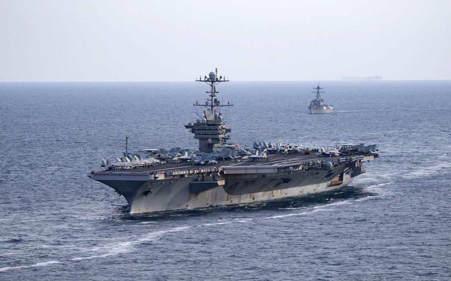 The aircraft carrier USS Harry S. Truman, front, and the guided-missile destroyer USS Lassen transit the Atlantic Ocean, July 18, 2019. The Truman's strike group has deployed while the ship remains docked, undergoing repairs on an electrical system that malfunctioned three weeks ago.