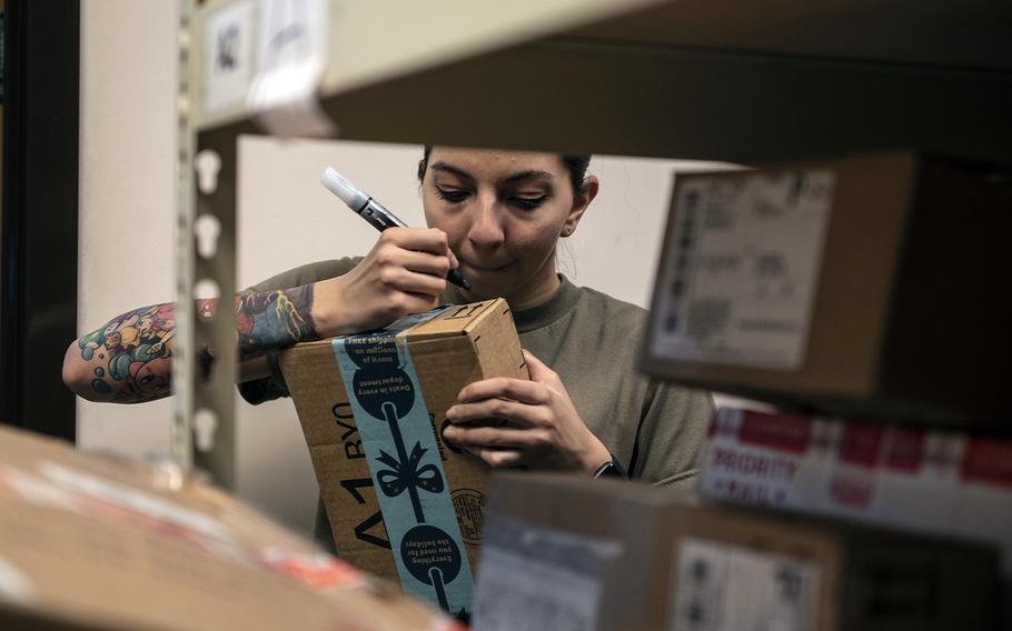 A volunteer helps sort holiday-season mail in the post office at Soto Cano Air Base, Honduras, Jan. 2, 2019.