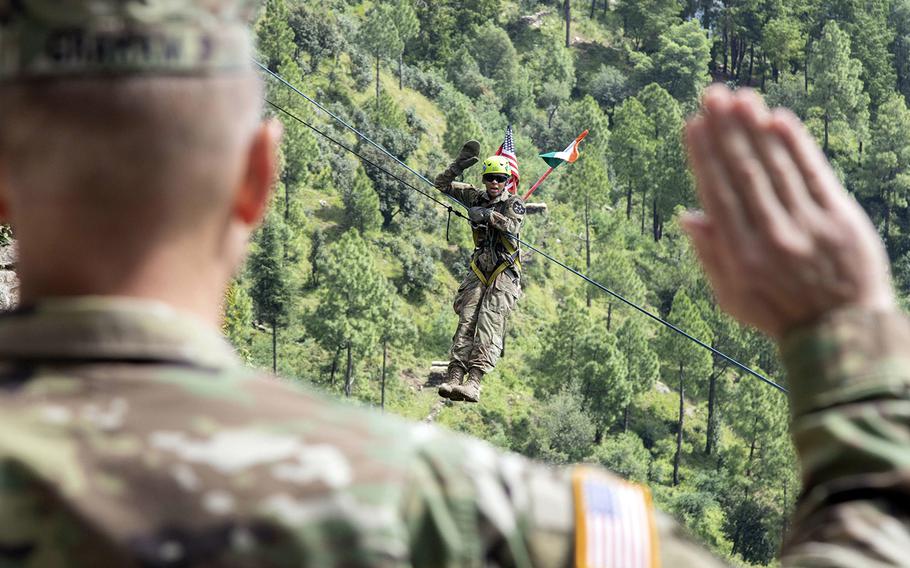 Army Spc. Sierra Hill, of 1-2 Stryker Brigade Combat Team, takes the oath of enlistment on a zipline at Chaubattia Military Station, India, Sept. 25, 2018, during Exercise Yudh Abhyas.