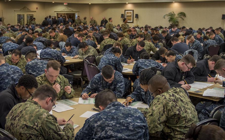 Sailors assigned to the aircraft carrier USS George H.W. Bush take the Navy-wide advancement exam at Norfolk Naval Shipyard, Va. in March 2019.  Some are wearing the type I uniform, also known as the blueberry because of its coloring, which will no longer be authorized for wear starting October 1, 2019.