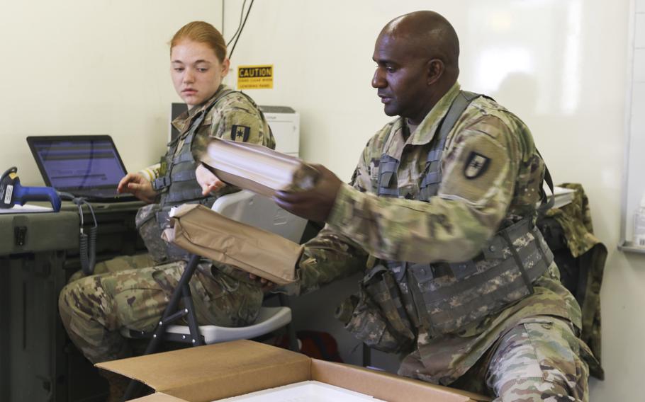 Spc. Yasmine Schmidt, left, a shipping and receiving specialist with the 432nd Blood Support Detachment, 28th Combat Support Hospital, 44th Medical Brigade, and Staff Sgt. James Mcneil, a lab noncomissioned officer in charge with the 432nd, scan and package freeze-dried plasma for air transportation, Sept. 19, 2019.