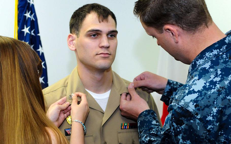 A sailor is pinned to petty officer first class during a frocking ceremony at Naval Air Facility Misawa, Japan, in 2016.