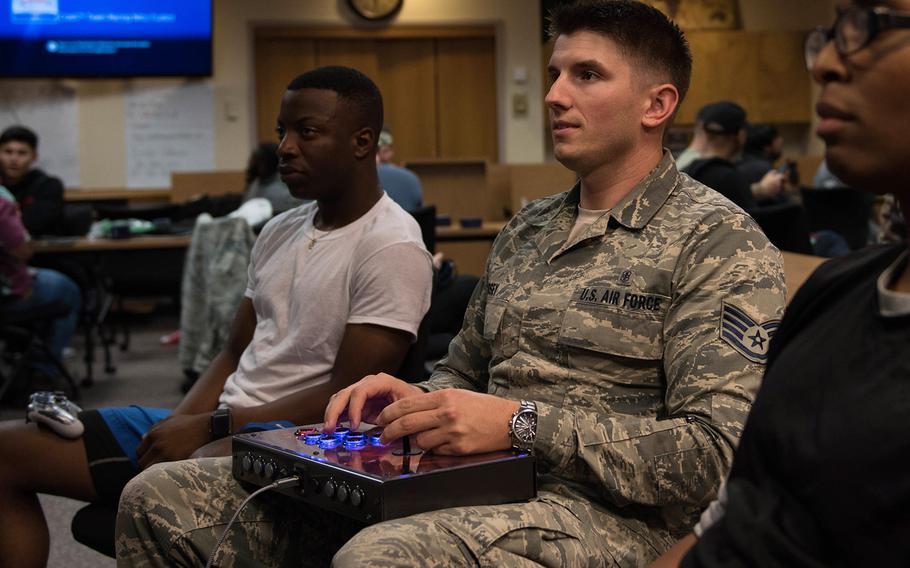 Air Force Staff Sgt. Sebastian Godsey, an aerospace medical technician for the 633rd Medical Group, plays a video game with other airmen at Joint Base Langley-Eustis, Va., Sept. 18, 2019.