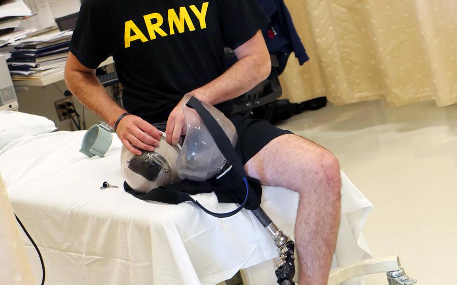 Spc. Ezra Maes adjusts his prosthetic leg prior to physical rehabilitation at the Center for the Intrepid, Brooke Army Medical Center's rehabilitation center on Joint Base San Antonio-Fort Sam Houston, Oct. 2, 2019.