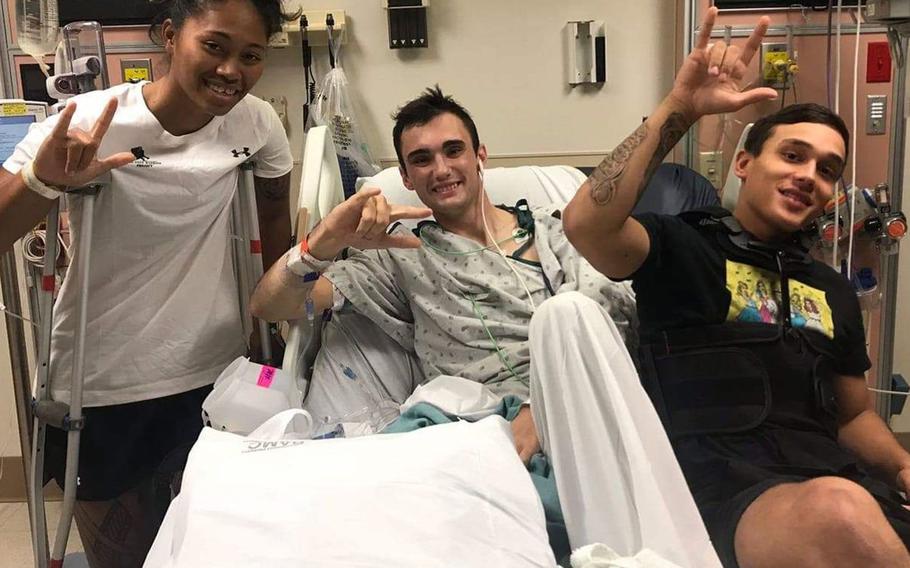 Sgt. Aechere Crump, left, and Pfc. Victor Alamo visit with Spc. Ezra Maes during their recovery at Brooke Army Medical Center. Crump and Alamo survived a tank accident in Slovakia with Maes in 2018.