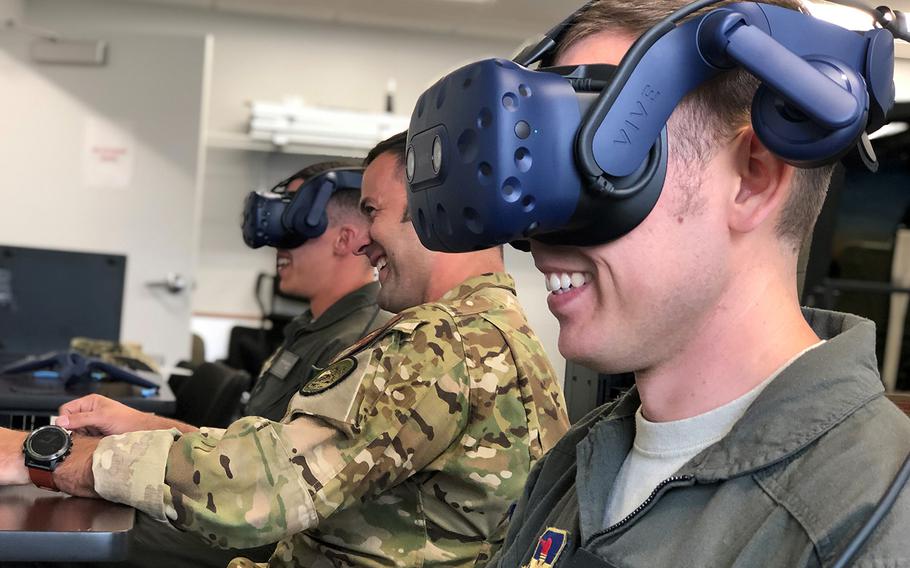 Air Force student-pilots work with an instructor from the 23rd Flying Training Squadron during a virtual reality simulator sortie, Oct. 9, 2019, at Fort. Rucker, Ala.