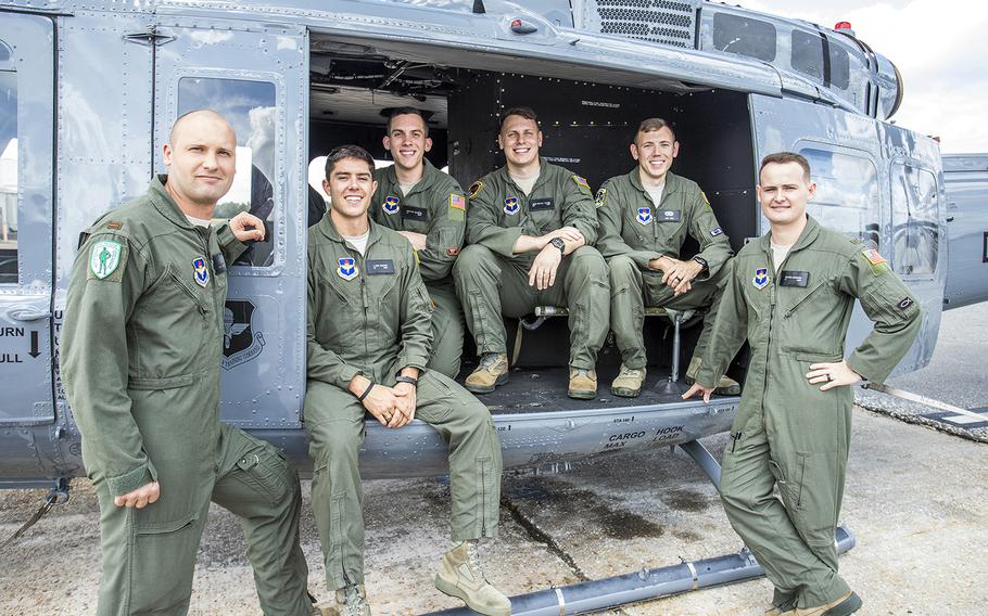 Air Force officers pose with a TH-1H helicopter at Fort Rucker, Ala., Oct. 10, 2019, after graduating from a pilot training program that tested virtual reality simulators and a new, shorter curriculum. They are, from left, 2nd Lt. Trent Badger, 2nd Lt. J. Karl Bossard, 1st Lt. Matthew Gulotta, 2nd Lt. John Thrash, Capt. Josh Park and 2nd Lt. Richard Songster.