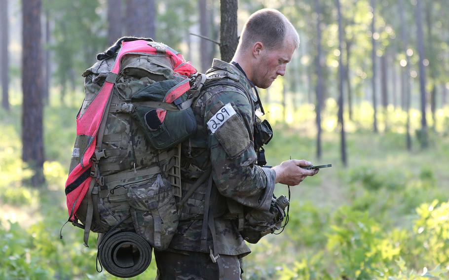 A soldier checks a compass while completing a land navigation course during Special Forces Assessment and Selection near Hoffman, N.C.,  May 7, 2019. Troops must be able to operate when technology no longer works, which means being better at battlefield maneuvers and land navigation, according to a new Army special operations strategy document.
