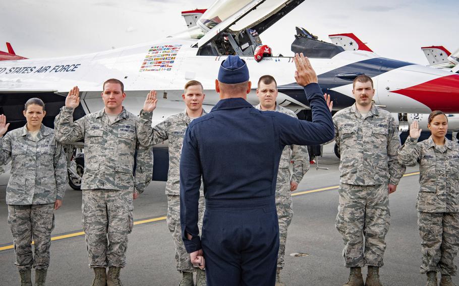 Lt. Col. Kevin Welsh, U.S. Air Force Air Demonstration Squadron commander, conducts an reenlistment in Anchorage, Alaska, June 29, 2018. Starting Nov. 18, airmen will be able to reenlist indefinitely after 12 years of service.