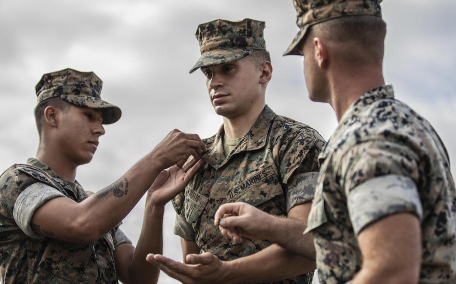 U.S. Marine Corps Cpl. Alexander Alfaro, a field artillery cannoneer assigned to 1st Battalion 11th Marines, 1st Marine Division, receives a Navy and Marine Corps Achievement Medal after being promoted to the rank of corporal at Marine Corps Base Camp Pendleton, September 26, 2019. The Corps is changing eligibility for promotion to sergeant and staff sergeant.