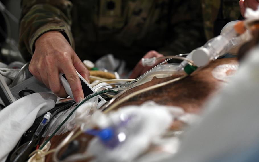 Lt. Col. Valerie Sams, a trauma surgeon with the 59th Medical Wing at Joint Base San Antonio, Texas, monitors a critically wounded soldier during a nonstop flight from Afghanistan to Texas, Aug. 18, 2019.