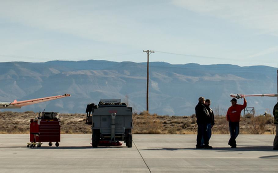 Ground crew of 82nd Aerial Target Squadron Detachment 1 perform maintenance on a QF-4 Phantom, left, a drone converted from an F-4 Phantom,  and its replacement, the QF-16, at Holloman AFB, N.M., Dec. 20, 2016.