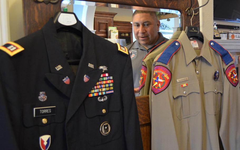 Le Roy Torres looks at the two uniforms that defined his adult life — his final dress uniform from 23 years in the Army and Army Reserve, from which he medically retired as a captain, and the final uniform he wore during his 14 years as a Texas state trooper. Torres sued the state of Texas in 2017 because he believes he was forced out of his job as a trooper due to injuries he sustained on deployment. 