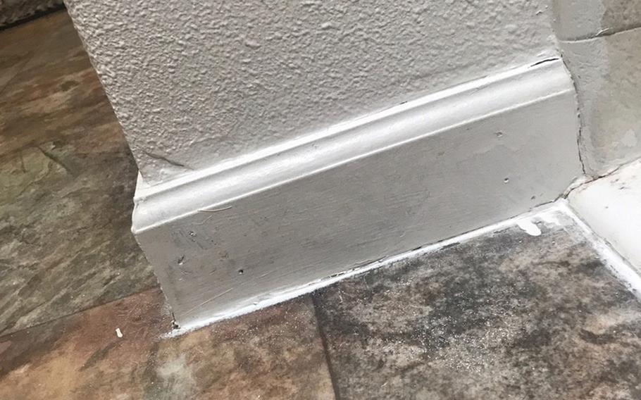 Mold on a baseboard was painted over by maintenance crews from Lincoln Military Housing. Melissa Godoy spent a year living in a home managed by the company at Joint Base Lewis-McChord, Wash. She said she intends to file a lawsuit against the company. 
