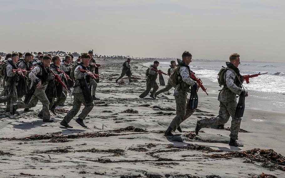 Marines taking part in the basic reconnaissance course run into the ocean at Naval Amphibious Base Coronado, Calif., Oct. 30, 2019.