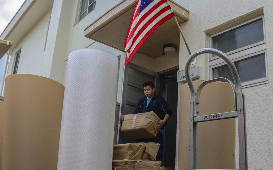 A mover takes a family's possessions from base housing at Yokosuka Naval Base, Japan, on Nov. 13, 2019.