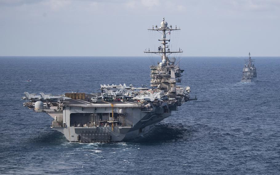 The aircraft carrier USS Harry S. Truman, front, and the Ticonderoga-class guided-missile cruiser USS Normandy transit the Atlantic Ocean, July 18, 2019.