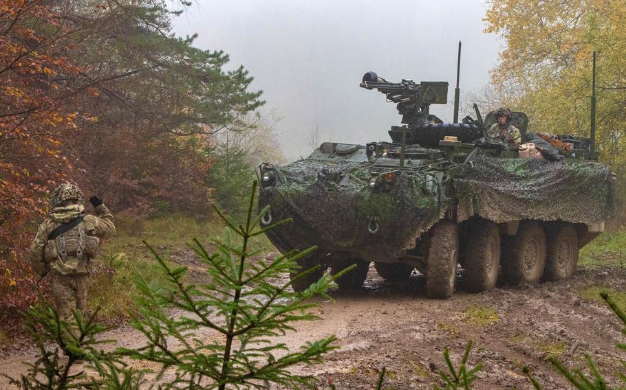 Soldiers with the 2nd Cavalry Regiment prepare to conceal a Stryker vehicle during Dragoon Ready exercise in Hohenfels, Germany, Nov. 3, 2019. The regiment will soon be heading to Poland in support of NATO's mission to deter Russia.