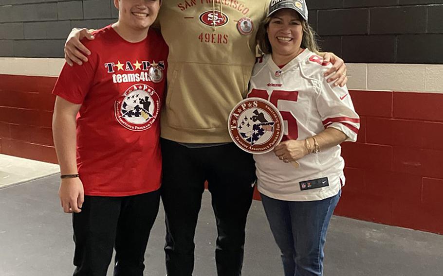 George Kittle, center, a tight end for the San Francisco 49ers, meets Jan. 24, 2020, with the family of Mick LaMar, a soldier who was killed in Iraq in 2011. Kittle met Nicolas LaMar, left, and Josie LaMar, right, as part of a program that gave service members and families a trip to the big game.
