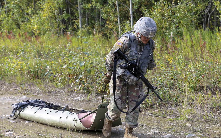 A member of the Alaska Army National Guard drags a 170-pound dummy in a simulated casualty evacuation during a competition at Joint Base Elmendorf-Richardson, Sept. 6, 2018.