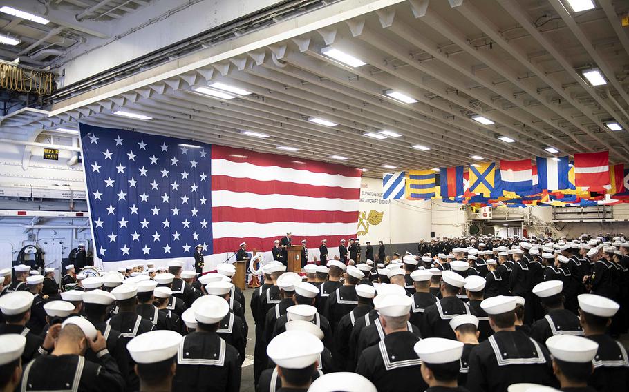 The crew of the San Diego-based USS Boxer gather in the hangar bay to mark the amphibious assault ship's 25th anniversary, Feb. 11, 2020.