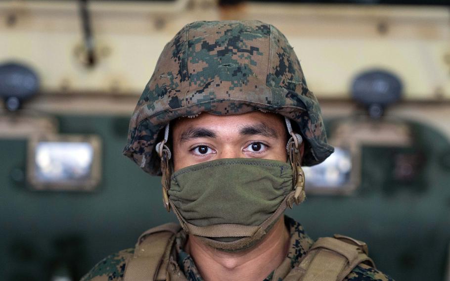 Marine Lance Cpl. Michael Ottinger wears a homemade face covering while posing for a photo on Camp Foster, Okinawa, Japan, April 7, 2020.