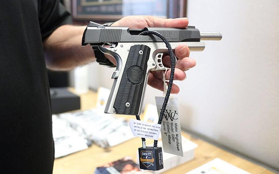 A pistol with a cable safety lock. The Air Force is distributing about 150,000 gun safety locks to bases in the U.S. as part of efforts to reduce suicides and accidental deaths, the service said.