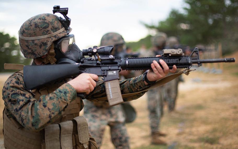 Marine Corps Pfc. Tyler Nelson fires an M16A4 rifle while wearing an M50 gas mask during a marksmanship training course on Camp Schwab, Okinawa, Japan, Dec. 3, 2019. Colt and FN America will compete to supply M16A4 rifles to Afghanistan, Grenada, Iraq, Lebanon and Nepal, the Pentagon announced.