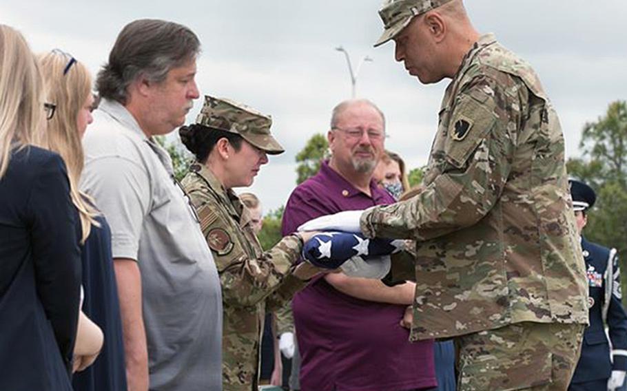 Maj. Gen. Michael Thompson, Oklahoma National Guard adjutant general, right, presents Tech. Sgt. Kristie Roberts, 138th Fighter Wing, with an American Flag during a memorial service for Tech. Sgt. Marshal Roberts, 138th Fighter Wing, in Claremore, Okla., on May 16, 2020. While deployed in support of Operation Inherent Resolve with the 219th Engineering Installation Squadron, Roberts was killed when his base was struck by multiple rockets in March.