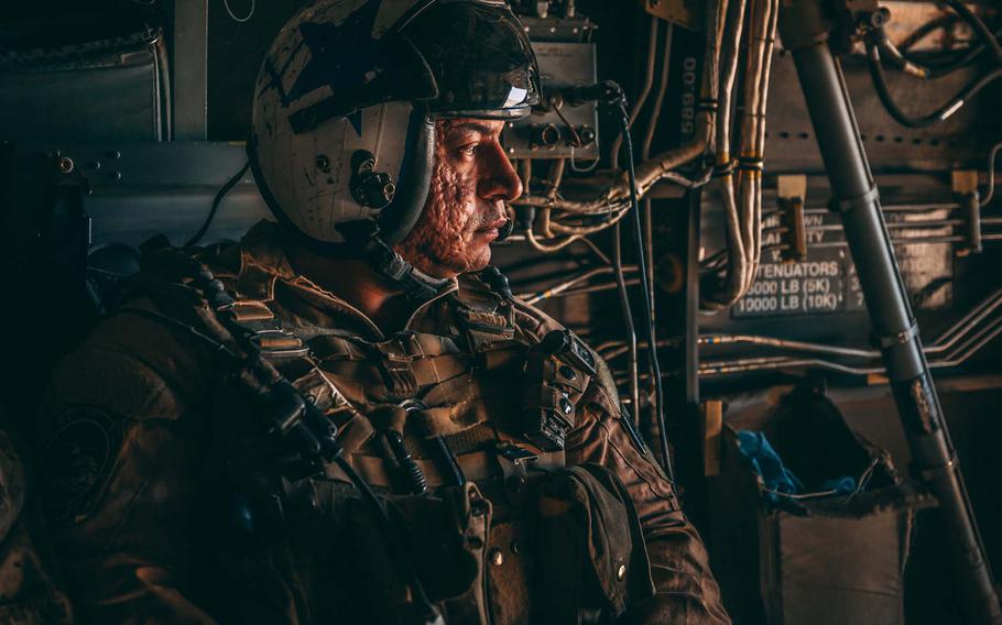 Gunnery Sgt. Saul Moreno, tiltrotor crew chief, Aircrew Training Detachment, 3rd Marine Aircraft Wing, monitors in-flight operations during the weapons and tactics instructor course 3-19, at Barry M. Goldwater Range, Wellton, Ariz., on April 17, 2019. This photo by Cpl. Jennessa Davey was part of a portfolio that earned her the Marine Corps' military photographer of the year award for 2019.