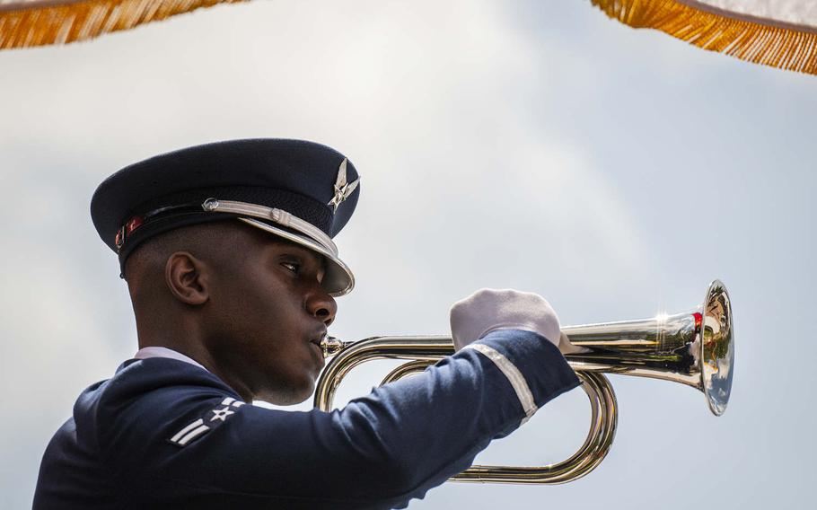 Airman 1st Class Giovanni Wilson, an honor guard at Eglin Air Force Base, Fla., holds a bugle playing taps during the 50th annual explosive ordnance disposal memorial service on May 4, 2019. This and other photos in Air Force civilian photographer Samuel King Jr.'s portfolio earned him the Defense Media Activity's civilian photographer of the year award for 2019.