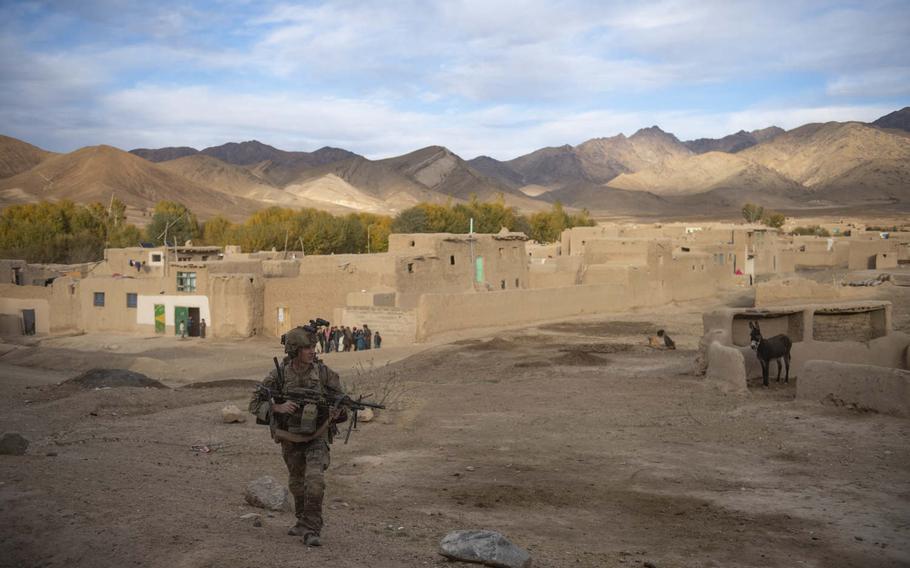 A U.S. Army soldier patrols through a village in an undisclosed location in Afghanistan on Nov. 4, 2019, in a photo from the portfolio that earned Staff Sgt. Alex Manne recognition as the Army's military photographer of the year.