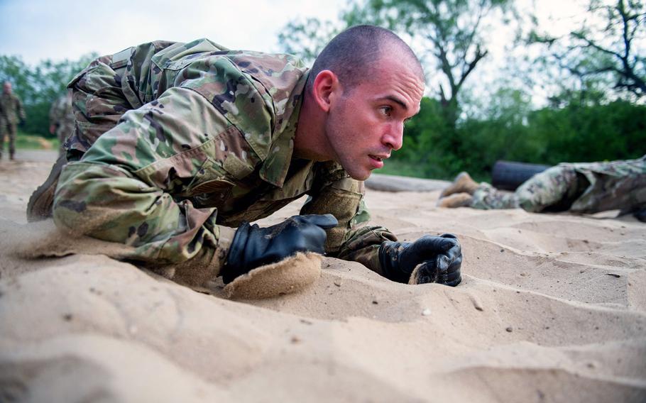 Airman Jose Vasquez-Vera goes through the Leadership Reaction Course June 9, 2020, at Joint Base San Antonio-Chapman Annex, Texas. Vasquez-Vera was taking part in the Air Force's Echo Flight program, which provides English language and cultural immersion before basic training.