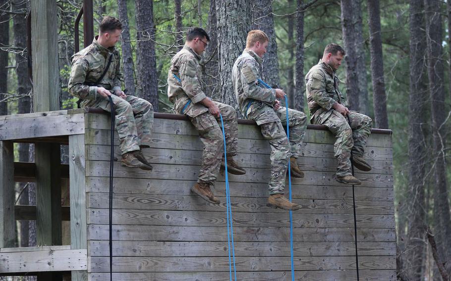 Students from the U.S. Army John F. Kennedy Special Warfare Center and School prepare to friction-rappel down a wall during the evasion phase of Survival, Evasion, Resistance and Escape Level-C training at Camp Mackall, N.C., March 21, 2020. More than 100 troops participating in the present course have been quarantined this week, after nearly most of them tested positive for COVID-19.