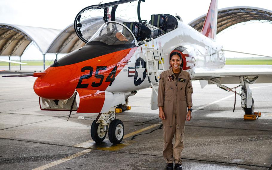 Student naval aviator Lt. j.g. Madeline Swegle, assigned to the Redhawks of Training Squadron (VT) 21 at Naval Air Station Kingsville, Texas, stands by a T-45C Goshawk training aircraft following her final flight to complete the undergraduate Tactical Air (Strike) pilot training syllabus, July 7, 2020. Swegle is the Navy's first known Black female strike aviator and will receive her wings during a ceremony July 31.