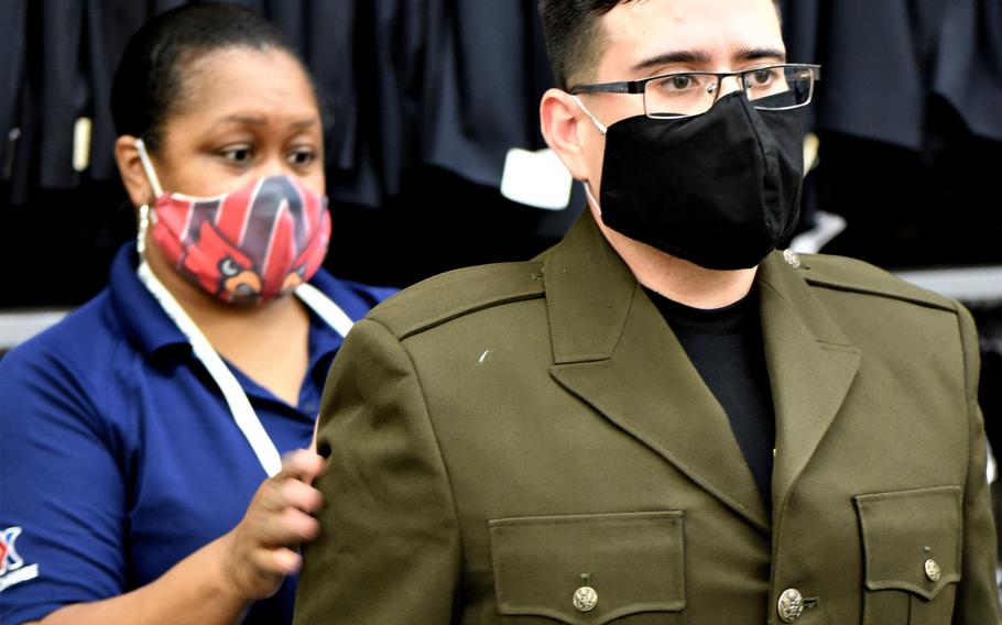 A Fort Knox, Ky., AAFES employee checks the fit of a new Army Green Service Uniform coat on a student recruiter on July 8, 2020. The recruiting students, who are about to graduate from the Army Recruiter Course at the installation, are some of the first to receive the World War II-style uniforms.