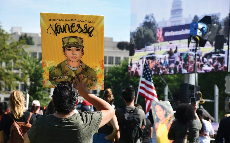 Activists hold signs depicting Spc. Vanessa Guillen at a rally July 30, 2020, in Washington, D.C. Guillen's family said Vanessa, who was killed at Fort Hood in April 2020, told them she was being sexually harassed but was too afraid to report it. 