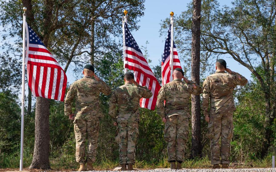 Members of 7th Special Forces Group (Airborne) salute during a memorial and awards ceremony on Friday, Aug. 21, 2020, at the group's compound on Eglin Air Force Base, Fla., where three stones were inscribed with the names of Green Berets from the unit's 1st Battalion who were killed in Afghanistan in 2019.