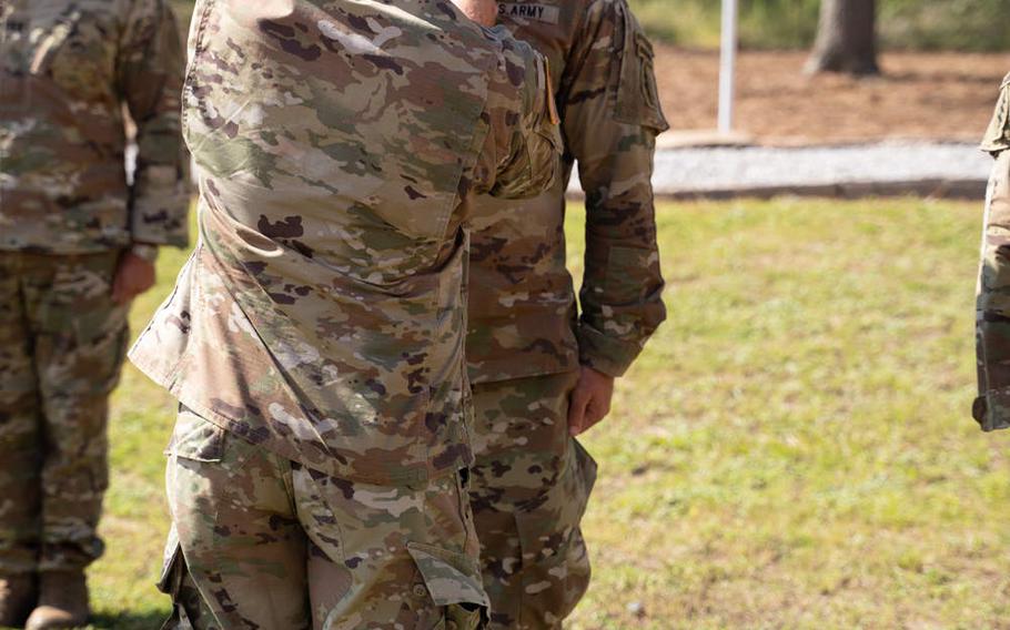 Lt. Gen. Francis Beaudette, commander of U.S. Army Special Operations Command, pins a medal on an unnamed member of 1st Battalion, 7th Special Forces Group (Airborne), during a memorial and awards ceremony at 7th Group's compound on Eglin Air Force Base, Fla., on Friday, Aug. 21, 2020. 