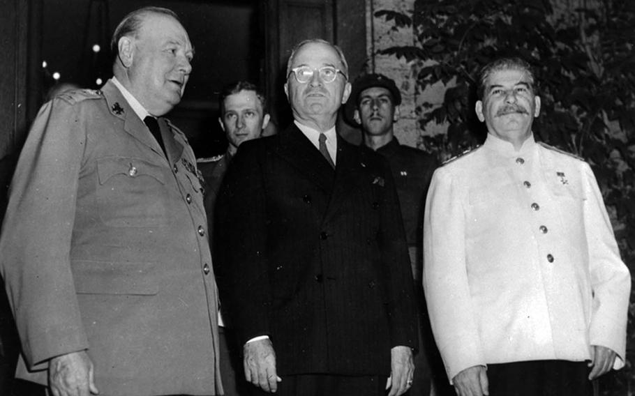 British Prime Minister Winston Churchill, left, President Harry Truman, center, and Soviet leader Joseph Stalin pose after dinner in Potsdam, Germany, July 23, 1945. U.S. Army Signal Corps