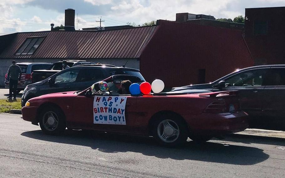 A car drives along as part of a parade for Ambrose ''Cowboy'' Anderson, 95, of Gloversville, N.Y., Aug. 28, 2020. Anderson received the New York State Liberty Medal from state Sen. Jim Tedisco on his birthday for his service as one of the first Black Marines. He joined the Marine Corps in 1943 and is a veteran of the Battle of Iwo Jima.