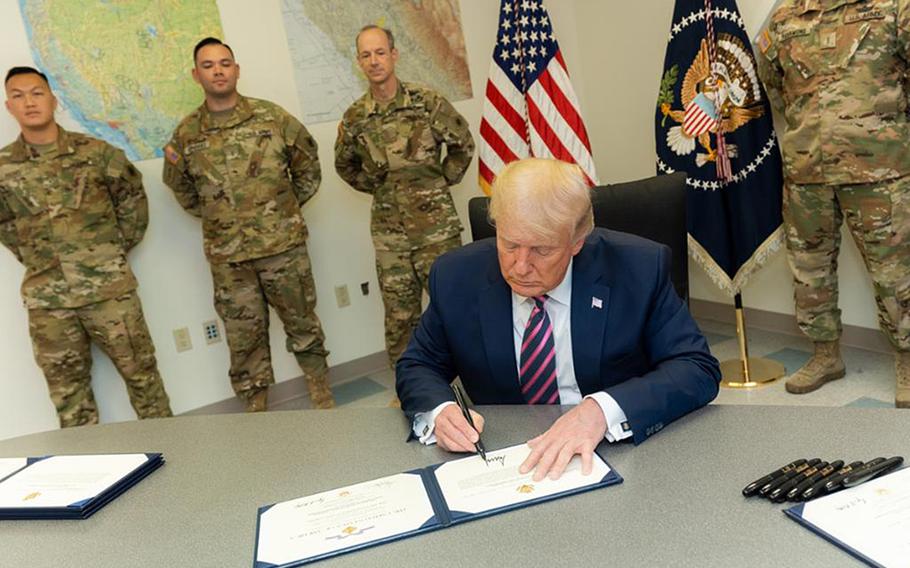 President Donald Trump honored seven members of the California National Guard with the Distinguished Flying Cross at a hangar in McClellan Park, Calif., on Sept. 14, 2020.