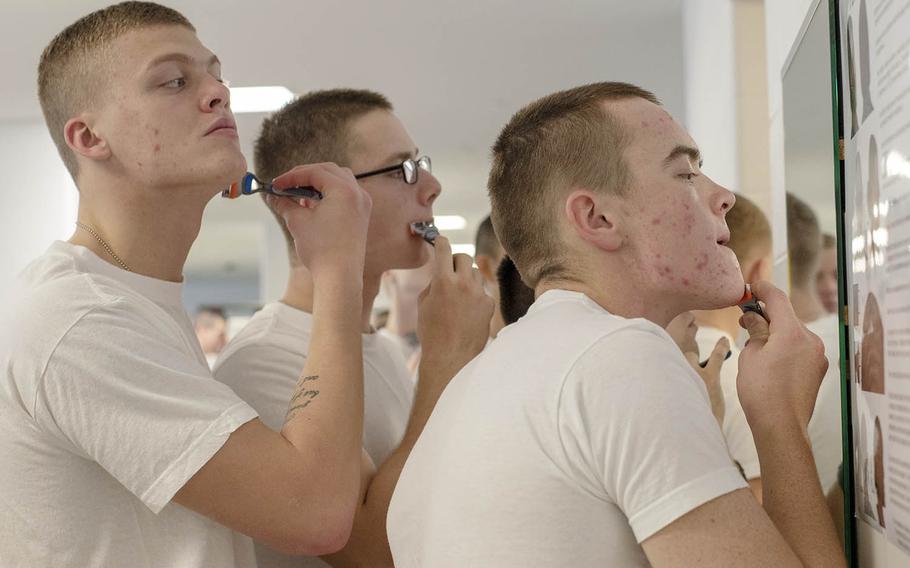 Recruits touch up their shave in preparation for an inspection inside their compartment in the USS Arleigh Burke barracks at Recruit Training Command, Oct. 31, 2018.