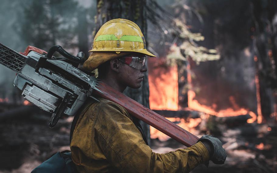 A Marine assigned to the 7th Engineer Support Battalion holds a fire line while conducting wildland fire fighting operations with National Interagency Fire Center personnel near the Sierra National Forest, Calif., Sep. 24, 2020.