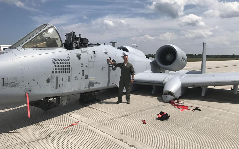 Capt. Brett DeVries, an A-10 Thunderbolt II pilot with the 107th Fighter Squadron, Selfridge Air National Guard base, Mich., poses next to the aircraft he safely landed after damage forced him to make an emergency landing July 20, 2017. He was awarded the Distinguished Flying Cross on Friday for his actions.