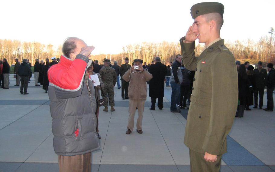 U.S. Marine Corps veteran Jack Zovack, left, salutes his nephew, then-2nd Lt. Patrick Weeks, for the first time at Weeks' commissioning ceremony in Quantico, Va., Dec. 11, 2009. Zovack, who served in WWII and Korea, wore civilian clothes for the ceremony.